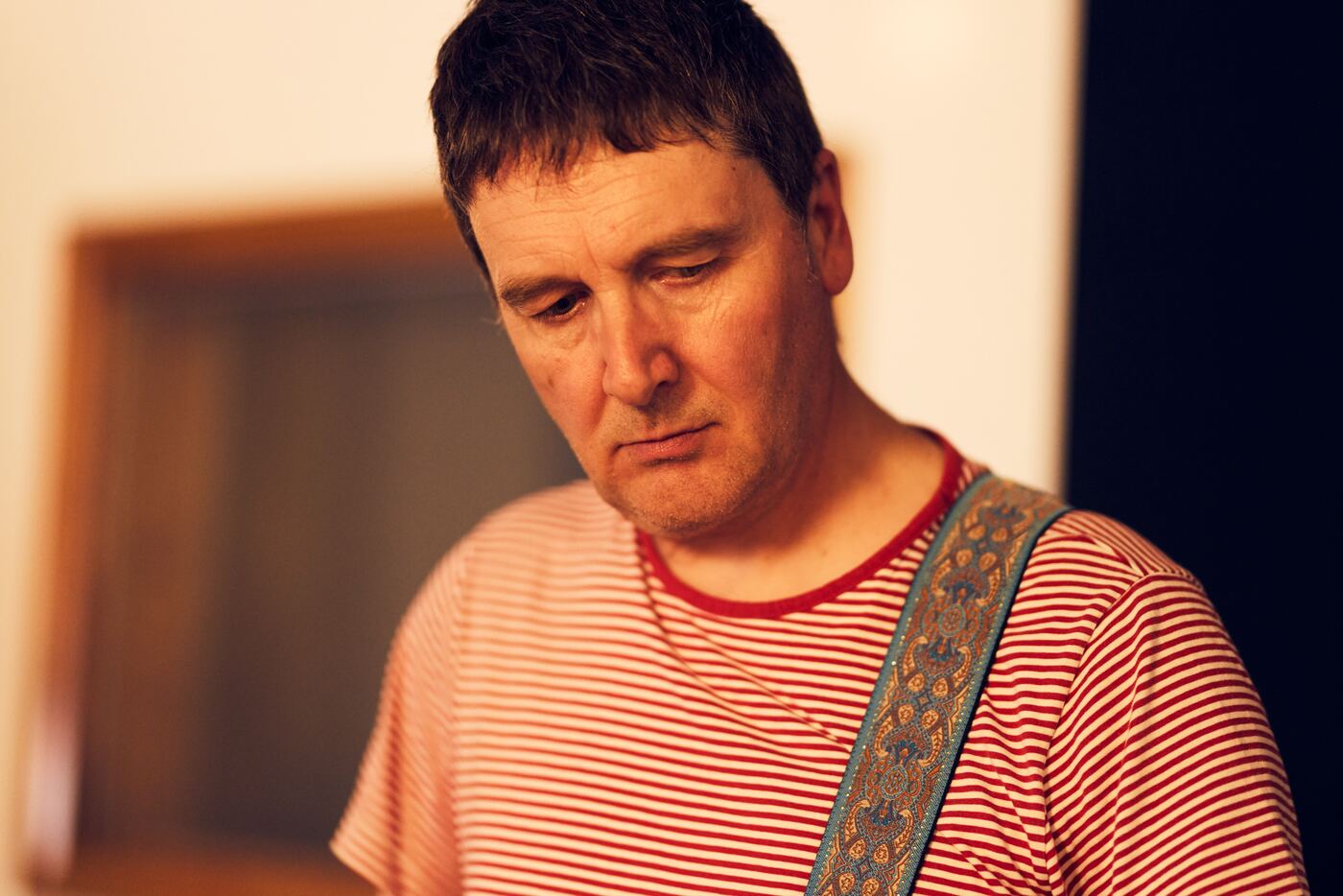 Rich looking down at his guitar